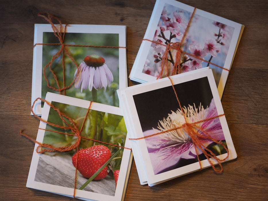 four packs of photo note cards bound with orange twine.