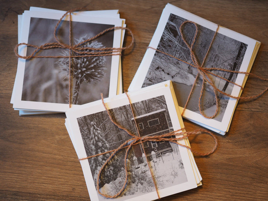 Three packs of note cards bound with orange twine.