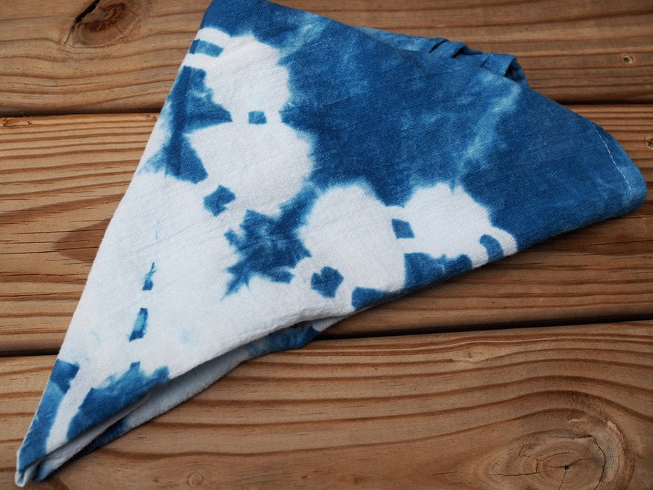 An indigo blue dyed tea towel folded into a triangle